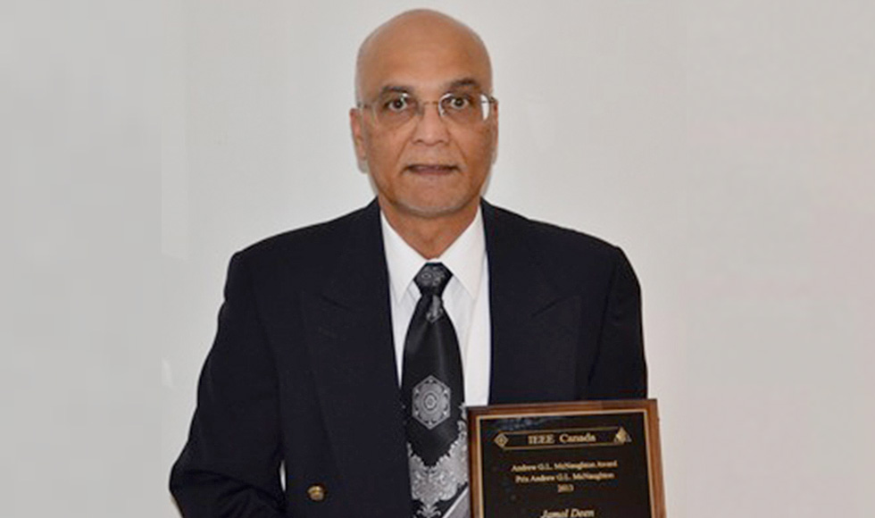 Jamal Deen, professor, Electrical and Computer Engineering, poses with his McNaughton Gold Medal and award plaque.